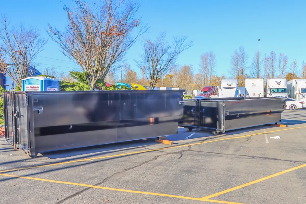 Professional dumpster rental service with roll-off container on residential driveway in Owasso